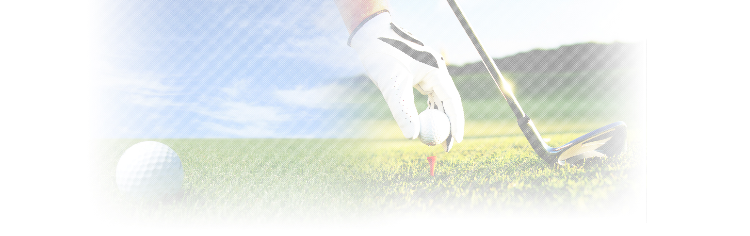 golfer holding golf ball while placing it on tee